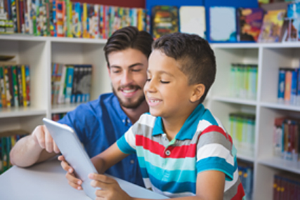 Kid reading with adult.